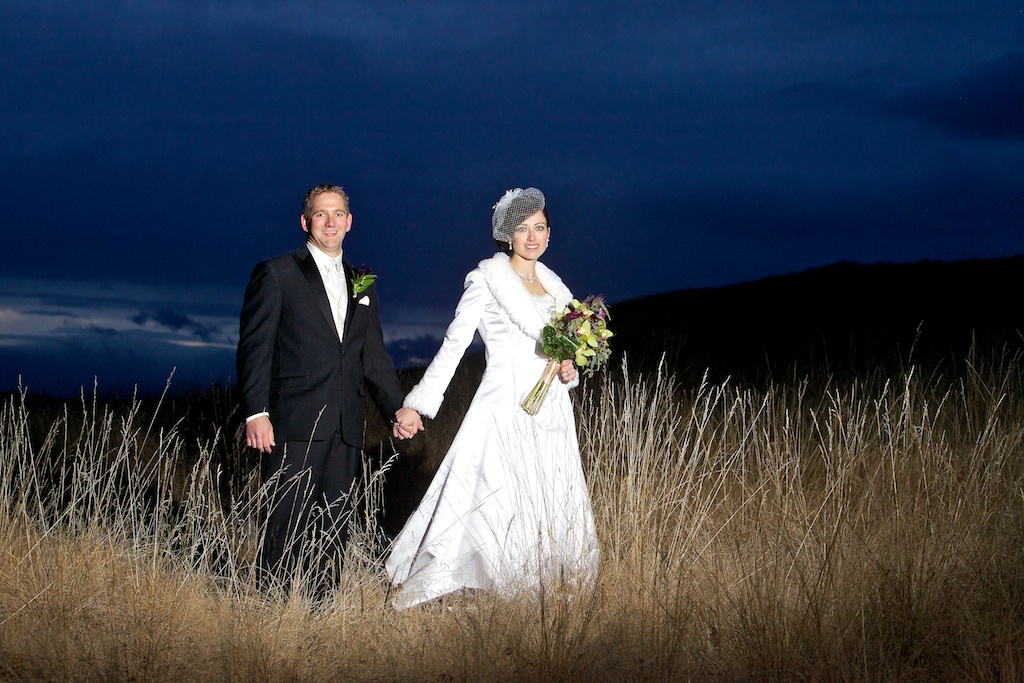 Calgary based wedding photographer | Cochrane Ranche House Wedding Photography | Bride and groom at night in field holding hands