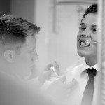 Banff Wedding Photographer | The Rimrock Hotel | Groomsmen getting ready brushing teeth