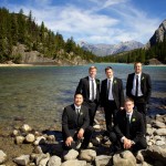 Banff Wedding Photographer | The Rimrock Hotel | Groomsmen group photo by the water | Mountains in the background