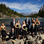 Banff Wedding Photographer | The Rimrock Hotel | Large bridal party group photo by water with mountains