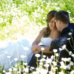 Banff Wedding Photographer | The Rimrock Hotel | Bride and groom sitting in flowers cuddling