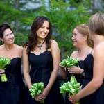 Banff Wedding Photographer | The Rimrock Hotel | Laughing bridesmaids black dresses with green flowers