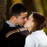 Calgary Wedding photography | Engagement photography | Fish Creek Park |Leaning agains tree kissing
