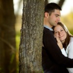 Calgary Wedding photography | Engagement photography | Fish Creek Park | Cuddling against a tree