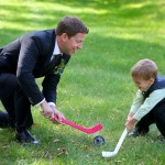 Calgary Wedding Photographer | Edmonton Vegreville wedding | groom playing hockey with ring barer