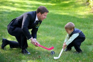 Calgary Wedding Photographer | Edmonton Vegreville wedding | groom playing hockey with ring barer