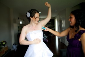 Christine & Peter Valley Ridge Golf Course wedding | Calgary Wedding Photography | Bride getting deodorant applied by friend