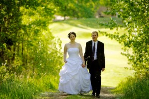 Christine & Peter Valley Ridge Golf Course wedding | Calgary Wedding Photography | Bride and groom walking up hill through tunnel of trees