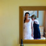 Destination wedding photographer | barcelo maya tropical resort Mexico | wedding photos | brides dress being done up in front of mirror