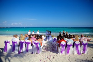 Destination wedding photographer | barcelo maya tropical resort Mexico | wedding photos | Beach wedding ceremony with white and purple chairs