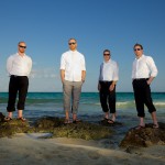 Destination wedding photographer | barcelo maya tropical resort Mexico | wedding photos | Groomsmen on rocks in the ocean