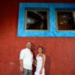 Destination wedding photographer | barcelo maya tropical resort Mexico | wedding photos | bride and groom red wall blue windows