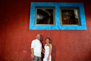 Destination wedding photographer | barcelo maya tropical resort Mexico | wedding photos | bride and groom red wall blue windows