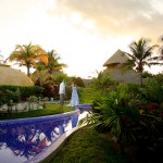 Destination wedding photographer | barcelo maya tropical resort Mexico | wedding photos | bride dancing by the pool with a sunset in the background