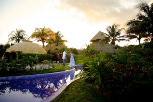 Destination wedding photographer | barcelo maya tropical resort Mexico | wedding photos | bride dancing by the pool with a sunset in the background
