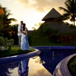 Destination wedding photographer | barcelo maya tropical resort Mexico | wedding photos | bride and groom watch sunset over hut