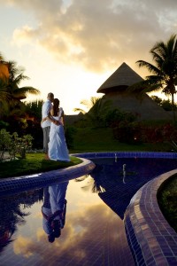 Destination wedding photographer | barcelo maya tropical resort Mexico | wedding photos | bride and groom watch sunset over hut