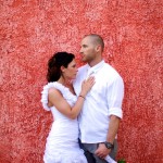 Destination wedding photographer | barcelo maya tropical resort Mexico | wedding photos | bride and groom in front of red wall | Groom holding flowers