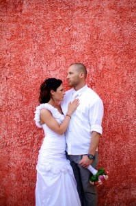 Destination wedding photographer | barcelo maya tropical resort Mexico | wedding photos | bride and groom in front of red wall | Groom holding flowers