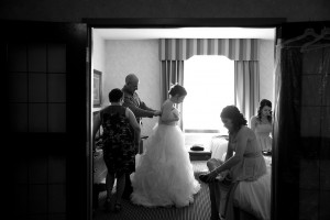 Calgary wedding photographer | Bride getting dress done up by mom and dad