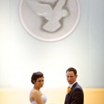 Calgary wedding photographer | Holy spirit catholic church wedding | bride and groom with dove in background