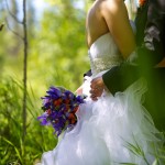 Calgary wedding photographer | Fish Creek Park wedding photos | Groom holding flowers and hugging bride in birch trees
