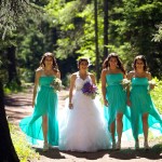 Calgary wedding photographer | Fish Creek Park wedding photos | Bride and bridesmaids walking down dirt path in trees
