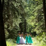 Calgary wedding photographer | Fish Creek Park wedding photos | Bride and bridesmaids walking down dirt path in tall trees