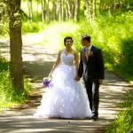 Calgary wedding photographer | Fish Creek Park wedding photos | Bride and groom walking down path in trees