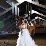 Calgary wedding photographer | Spruce Meadows wedding photos | Bride standing with a horse in a warmup ring