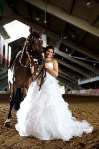 Calgary wedding photographer | Spruce Meadows wedding photos | Bride posing with a horse in a warmup ring