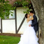 Calgary wedding photographer | Spruce Meadows wedding photos | Bride and groom leaning against a tree kissing passionately