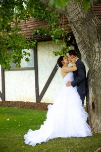 Calgary wedding photographer | Spruce Meadows wedding photos | Bride and groom leaning against a tree kissing passionately