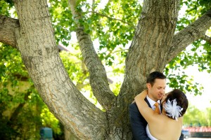 Calgary wedding photographer | Spruce Meadows wedding photos | Bride and groom leaning against a tree hugging